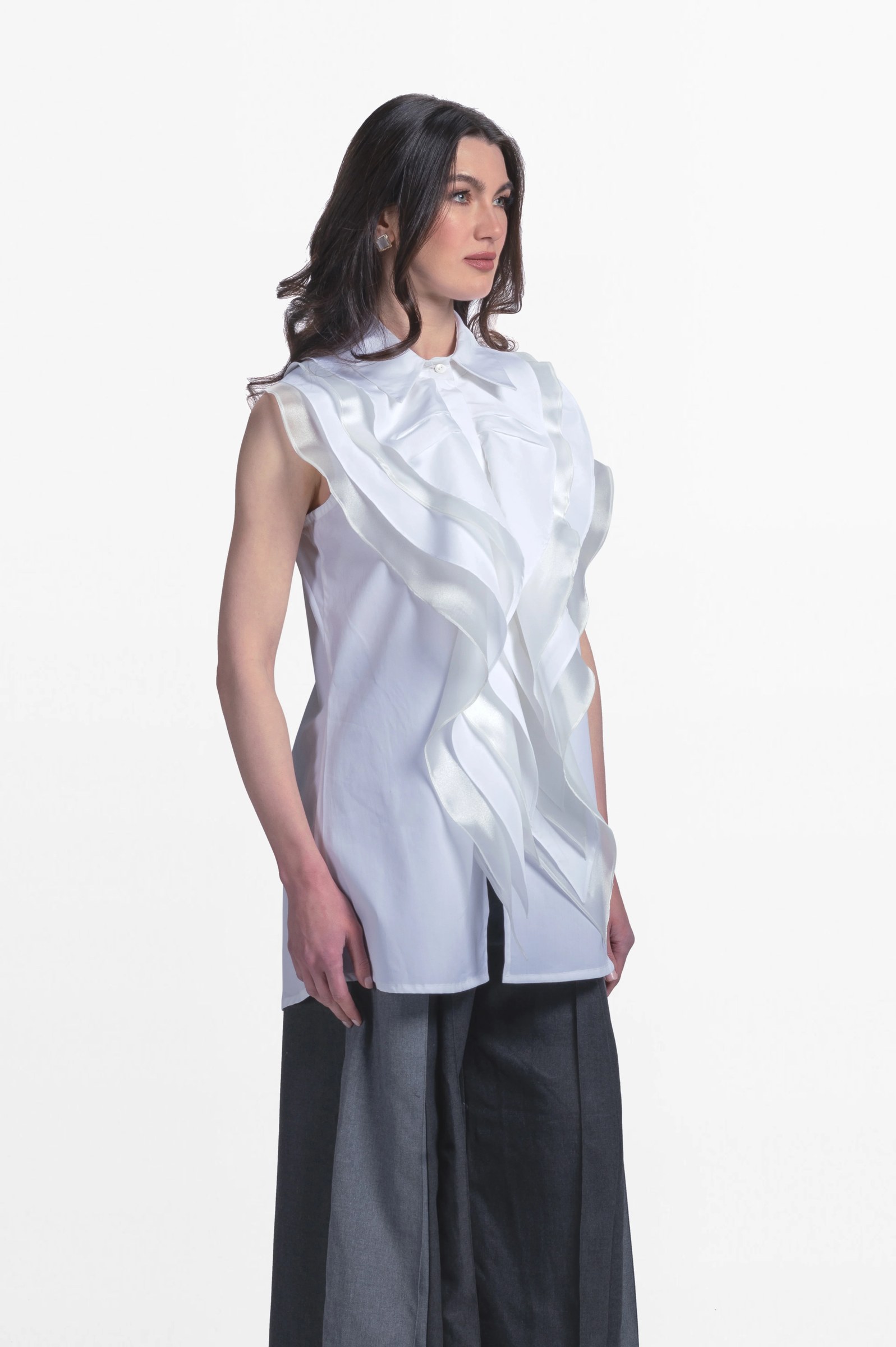 Sleeveless blouse with front ruffles.